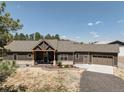 A charming ranch-style home showcases a welcoming front porch, attached garage, and neutral exterior colors at 5917 Black Forest Dr, Elizabeth, CO 80107