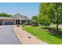 Beautifully landscaped front yard with mature trees and gravel accents leading up to a well-maintained home at 7126 E 162Nd Ct, Brighton, CO 80602