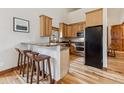 Charming kitchen features light wood cabinets and a convenient breakfast bar at 1152 Ski Hill Rd, Breckenridge, CO 80424