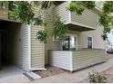 View of building exterior showing private balcony, and access, all surrounded by beautiful landscape at 10150 E Virginia Ave # 5-107, Denver, CO 80247