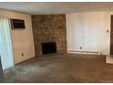 Living room features a stone fireplace and carpet flooring at 10150 E Virginia Ave # 5-107, Denver, CO 80247