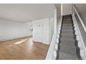 Inviting living room showcasing hardwood floors and staircase with neutral carpet at 6905 Mariposa St # C, Denver, CO 80221