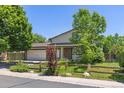 Charming two-story home with mature trees and a well-manicured lawn at 1584 S Fraser Way, Aurora, CO 80012