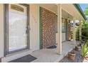 Inviting front porch with brick accents, decorative plants and hanging baskets at 1584 S Fraser Way, Aurora, CO 80012