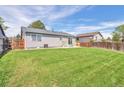 Expansive backyard featuring a well-maintained lawn and a charming patio area, perfect for outdoor entertaining at 4182 S Joplin St, Aurora, CO 80013