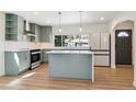 Modern kitchen features sleek appliances, stylish cabinetry, a center island, and ample counter space at 1430 S Glencoe St, Denver, CO 80222
