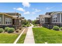 Beautiful community featuring manicured lawns, charming homes, and inviting walkways in a serene setting at 15501 E 112Th Ave # 6F, Commerce City, CO 80022