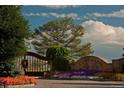 Stone entrance to Colorado Golf Club featuring seasonal flowers and foliage at 8625 Eagle Moon Way, Parker, CO 80134