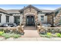Inviting front porch with stone accents offers a relaxing outdoor seating area at 8625 Eagle Moon Way, Parker, CO 80134