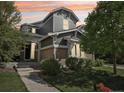 Stylish home with a combination of siding and brick, featuring manicured landscaping and an inviting entrance at 25548 E Fair Dr, Aurora, CO 80016
