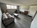 Inviting living room with gray walls, wood-look floors, a comfy sofa, and a large window at 9440 E Girard Ave # 1, Denver, CO 80231
