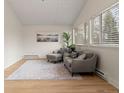Bright living room featuring wood floors, comfortable seating, large windows, and a tranquil atmosphere at 712 S Longmont Ave, Lafayette, CO 80026