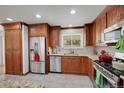 Modern kitchen with stainless steel appliances, granite countertops, and ample cabinet space at 2694 S Krameria St, Denver, CO 80222