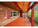 Relaxing deck featuring beautiful wood ceiling, exposed beams, and gorgeous railing design at 29832 Dorothy Rd, Evergreen, CO 80439