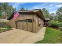 Exterior view of house featuring a large garage, well manicured lawn, and beautiful dark siding at 29832 Dorothy Rd, Evergreen, CO 80439