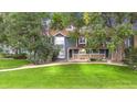 Charming exterior view showcases the home's well-kept lawn and inviting facade with stone accents at 3807 Paseo Del Prado, Boulder, CO 80301