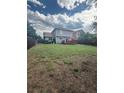 Large backyard with spacious lawn, wood fence, and deck, perfect for outdoor living at 2551 W 58Th W Ave, Denver, CO 80221
