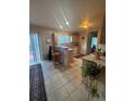 Bright kitchen featuring tile floors, a breakfast bar, and ample cabinet space at 2551 W 58Th W Ave, Denver, CO 80221