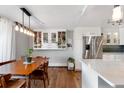 Open floor plan view of dining area and kitchen with stainless steel refrigerator and island with marble countertop at 1090 N Lafayette St # 503, Denver, CO 80218
