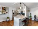Modern kitchen with stainless steel appliances, white cabinets, marble countertop, and counter seating at 1090 N Lafayette St # 503, Denver, CO 80218