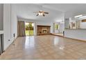 Spacious living room features a cozy brick fireplace and sliding glass doors to the backyard at 18874 E Colorado Dr, Aurora, CO 80017