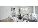 Bright living room showcasing modern decor, large windows, and comfortable seating at 1809 W Crestline Dr, Littleton, CO 80120