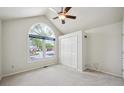 Bright bedroom with vaulted ceiling, large window, neutral carpet, and a closet at 9214 Winona Ct, Westminster, CO 80031