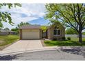 Charming single-story home with a well-manicured lawn and attached garage at 9214 Winona Ct, Westminster, CO 80031