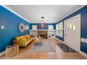 Bright living room featuring hardwood floors, a cozy fireplace, and abundant natural light at 1401 Ash St, Denver, CO 80220