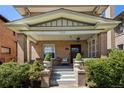 Inviting front porch with seating area perfect for relaxing and enjoying the outdoors at 1265 Saint Paul St, Denver, CO 80206
