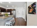 Modern kitchen with granite countertops, stainless steel appliances, and dark wood cabinets at 480 E Fremont Pl # 308, Centennial, CO 80122