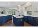 Spacious kitchen with blue cabinets, white countertops, and stainless steel appliances at 329 Bobcat Pt, Lafayette, CO 80026