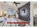 A bright bedroom boasts a ceiling fan, a patterned accent wall, a window, and stylish decor at 4100 Albion St # 221, Denver, CO 80216