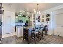 Open dining area with modern light fixture and kitchen access, perfect for entertaining guests at 4100 Albion St # 221, Denver, CO 80216
