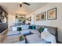 Open concept living room boasts a spacious sectional sofa and decor throughout at 4100 Albion St # 221, Denver, CO 80216