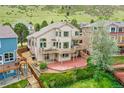 Multi-level deck and patio provide scenic outdoor living spaces, backing to green space at 165 Washington St, Golden, CO 80403