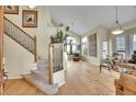 Bright living room featuring hardwood floors, high ceilings, staircase, large windows, and modern decor at 165 Washington St, Golden, CO 80403