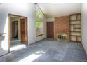 Bright living room with vaulted ceiling, brick fireplace, and large windows offering ample natural light and a cozy atmosphere at 11884 Elk Head Range Rd, Littleton, CO 80127