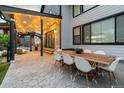 Outdoor patio area featuring a dining table with seating for eight, a grill, and string lights at 27250 E Nova Cir, Aurora, CO 80016