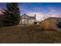 Charming exterior of a Tudor home with a well-maintained lawn and mature tree at 1190 Glencoe St, Denver, CO 80220