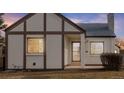 Close up of house at 1190 featuring Tudor details and tidy front yard at 1190 Glencoe St, Denver, CO 80220