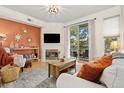 Cozy living room with a fireplace, balcony access, and stylish decor creating an inviting space at 2169 Eagle Ave # 2169, Superior, CO 80027