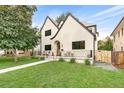 A beautiful house showcases its unique architectural design, lush lawn, and a charming outdoor seating area at 659 Albion St, Denver, CO 80220