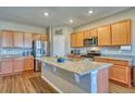 Spacious kitchen featuring a large island with granite countertops and stainless steel appliances at 6221 N Easton Ave, Frederick, CO 80504