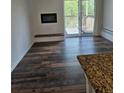 This living room has a fireplace, updated flooring and access to a balcony at 1304 S Parker Rd # 13, Denver, CO 80231