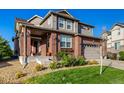 Charming brick home with a well-kept lawn and landscaping, showcasing the inviting front entrance at 27029 E Irish Pl, Aurora, CO 80016