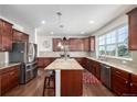 Modern kitchen with granite countertops, stainless steel appliances, and a spacious island at 27029 E Irish Pl, Aurora, CO 80016