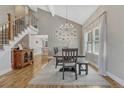 Open dining room with high ceilings, hardwood floors, and a modern chandelier, perfect for entertaining guests and Gathering at 7444 S Milwaukee Ct, Centennial, CO 80122