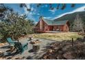 Home with fire pit, Adirondack chairs and mountain views at 804 Clear Creek Rd, Evergreen, CO 80439