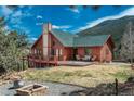 Home with outdoor furniture and mountain views at 804 Clear Creek Rd, Evergreen, CO 80439